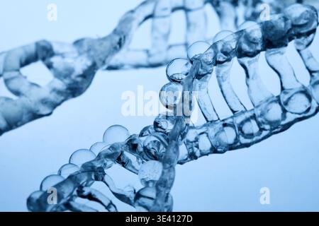 Abstract cosmetic lab. Dna double helix structure forming with clear liquid Stock Photo