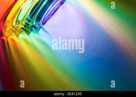 Glass prism refracting light creating vibrant spectrum colors Stock Photo