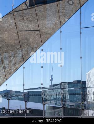 A captivating photograph showcasing the vibrant skyline of Berlin, Germany, reflected in the glass facade of a modern building. The iconic Fernsehturm Stock Photo