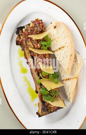 Bone marrow with beef tartare and bread slices Stock Photo