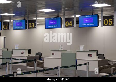 Airport Check-in Counters with Flight Displays and Passenger Service Area Stock Photo