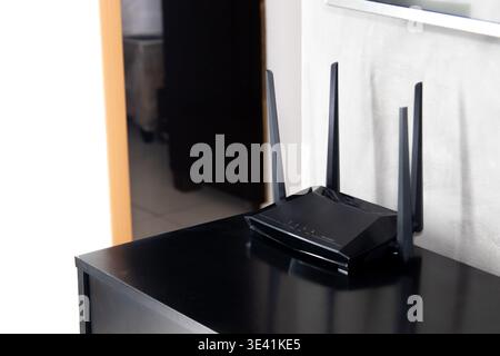 Wi-Fi Router with Four Antennas on Furniture in a Residential Setting Stock Photo