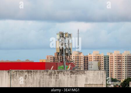 Telecommunications antenna installed on the roof of a residential building. Stock Photo