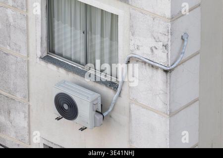 Outdoor Air Conditioning Unit Installed on Residential Facade Stock Photo