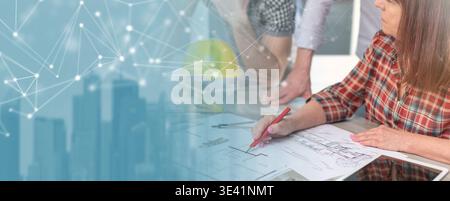 Architects working on plans at office; panoramic banner Stock Photo