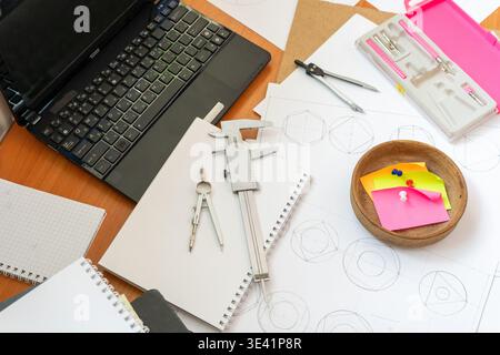 Engineer Workspace Laptop, Technical Drawings, Vernier Caliper, Compasses Stationery Tool Top view architect desk Geometric sketches dividers. Professional engineering and drafting Stock Photo