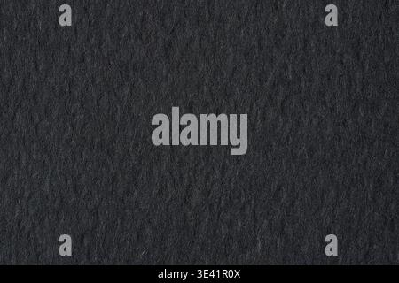 Black paper texture background with rough grain and dark dramatic tone Stock Photo