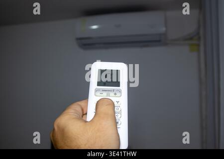 Remote control for air conditioning in a residential setting. Stock Photo