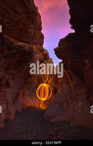 Steel Wool Light Painting in Slot Canyon at Blue Hour with Vibrant Evening Sky Stock Photo