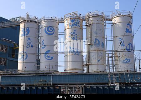 Decorated silo tanks at the former Lever Brothers and Unilever Persil factory beside Warrington Bank Quay station. Stock Photo