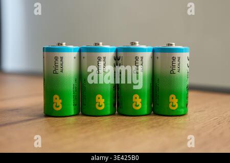 Tyumen, Russia-March 20, 2026: Batteries from GP brand are arranged in a row on a wooden surface with a bright background Stock Photo