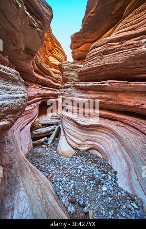 Colorful Eroded Sandstone Walls and Pebble Floor in Dramatic Slot Canyon Landscape Stock Photo