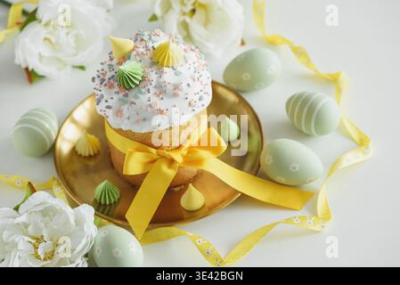 Easter Cake Decorated Yellow Ribbon with Flowers and Pastel Eggs on White Background Stock Photo
