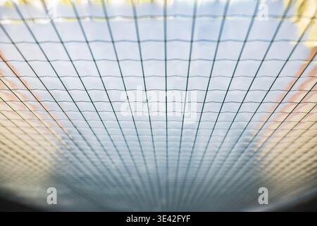 Grid pattern creating a texture with converging lines, providing an abstract background Stock Photo