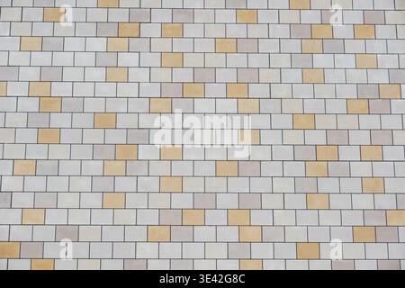 Ceramic tile wall background displaying beige and cream rectangular patterns Stock Photo