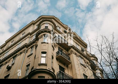 Corner residential building with balconies and decorative elements in Belgrade. Concept of urban living, housing market and European architecture Stock Photo