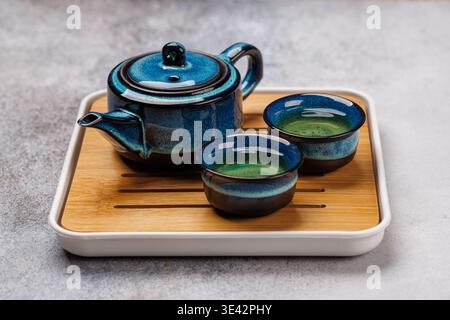 Traditional tea ceremony with teapot and cups in Japanese or Chinese style, calm cultural atmosphere Stock Photo