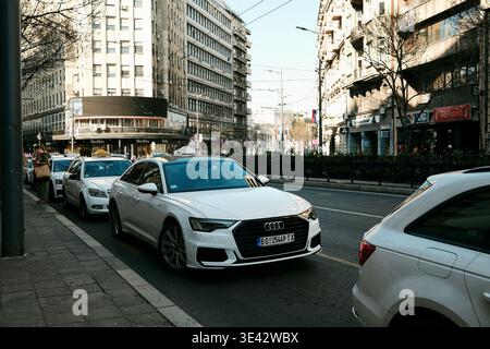 Urban street scene in Belgrade with taxi cars and daily traffic flow, suitable for transportation, mobility and modern city lifestyle concepts Stock Photo