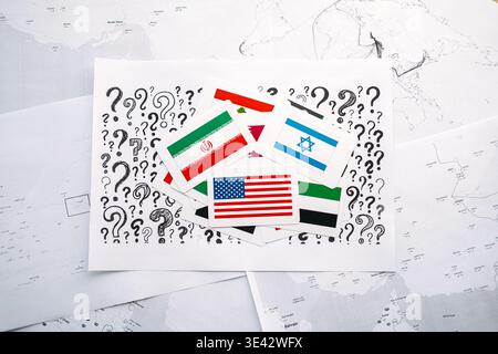 flags for USA, ISRAEL, IRAN, and other nations lie on paper with question marks over geographic maps. USA Israel Iran, Middle East crisis, complex Stock Photo