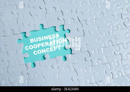 Piece of jigsaw puzzle with word business cooperation concept Stock Photo