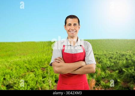 Portrait of a happy farmer posing with his arms crossed in a vineyard at Spain Stock Photo
