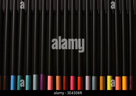 Colorful pencils arranged on a rustic wooden table, creating a vibrant and creative background. Bright tones, natural textures Stock Photo
