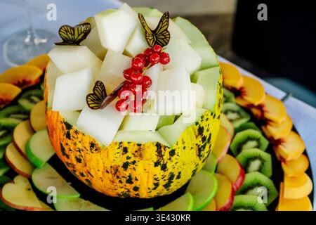 Melon Bowl Filled With Fresh Fruit Slices Hollowed Melon Used As Bowl Containing Honeydew Cubes . Stock Photo