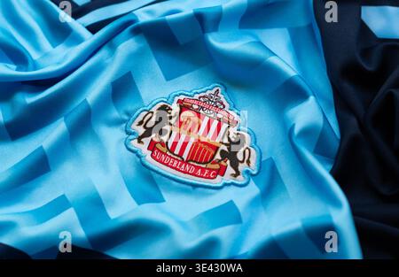 Kyiv, Ukraine, April 30, 2025.. Close-up of Sunderland A.F.C. football jersey showing club crest on light blue textured fabric Stock Photo