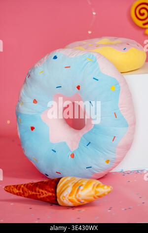 Sweet Colorful Pillow. Decorative Studio Shot Featuring Donut Cushion And Sprinkles Stock Photo