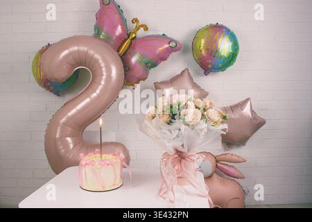 2nd Birthday Decor: pink balloons and bunny, bouquet. Photo zone Stock Photo