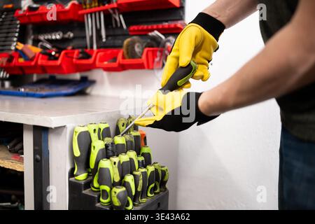 Mechanic Choosing A Screwdriver In Screwdriver Set At An Auto Service Stock Photo