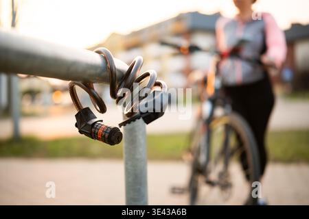 Bike Code Lock Against Female Bike Rider On A Bicycle Parking Rack Stock Photo