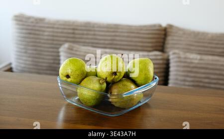 Green Pears In A Bowl On The Table In The Living Room Stock Photo