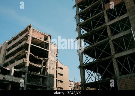 Partially destroyed building in Belgrade with exposed concrete structure reflecting urban decay, post-conflict history and transformation of the city Stock Photo