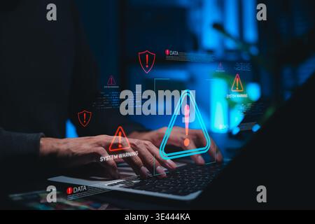 Cybersecurity warning and data threat detection concept. Person using laptop with alert icons, system warning messages, and danger symbols, cyber risk Stock Photo