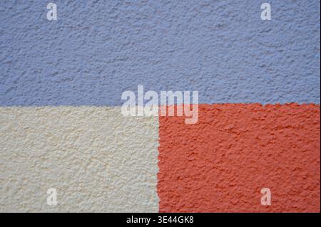 Three-color stucco wall texture for graphic design. Vertical split pattern background with lavender, cream, and terracotta rough plaster Stock Photo