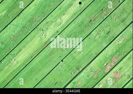Diagonal green wooden planks texture with peeling paint, rustic weathered timber background, vintage wood wall Stock Photo