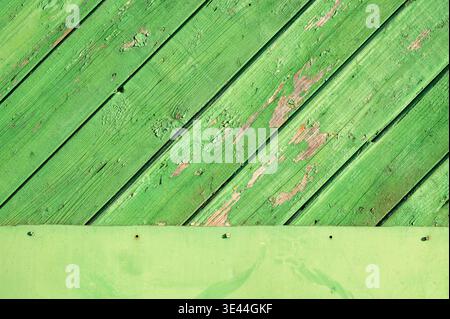 Green weathered wooden planks and flat panel texture for graphic design. Diagonal wood background with peeling paint and rustic surface Stock Photo