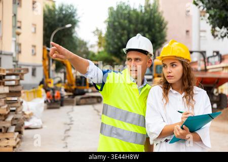 Civil engineers checking work process in construction site Stock Photo