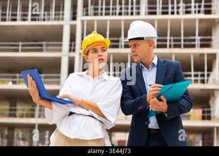Two architects with laptop discussing construction plan Stock Photo