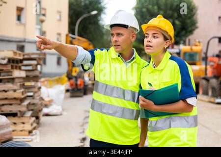Two qualified engineers are discussing a construction plan Stock Photo