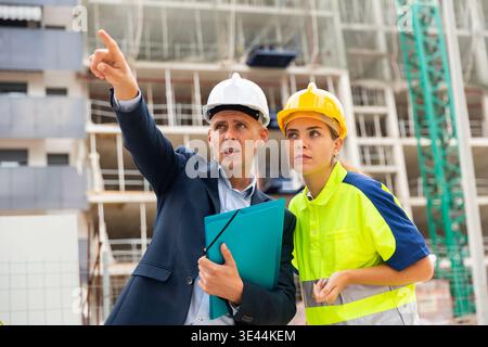 Civil engineers checking work process in construction site Stock Photo