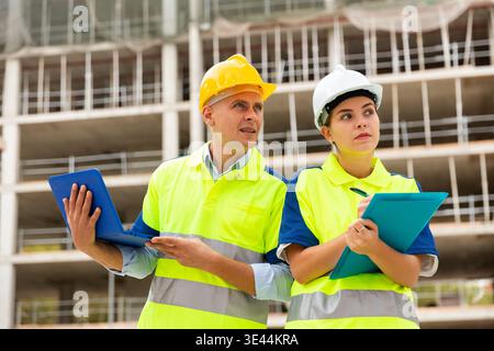 Two architects with laptop discussing construction plan Stock Photo