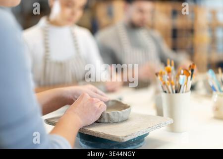 Close up master forms bowl of clay during master class Stock Photo