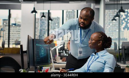 Portfolio managers using artificial intelligence to analyze stock market trends and enhance investment returns. Coworkers use AI chatbot to identify investment opportunities Stock Photo