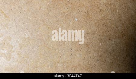 Detailed macro view of a light brown fibrous material showing its natural organic texture possibly recycled paper or cardboard with speckled detail Stock Photo