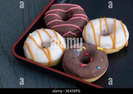 Donuts in close-up on a wooden background Stock Photo