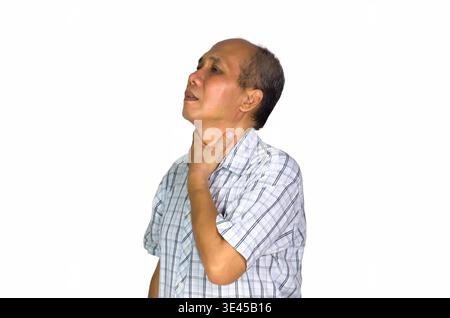 Sore throat. Asian man holding his inflamed throat. Photo of asian man in checkered shirt on white background. Medical concept Stock Photo