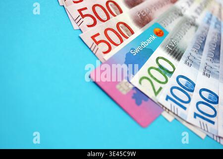 KYIV, UKRAINE - JANUARY 28, 2026 Swedbank card and Swedish krona money bills on table close up. Swedbank is most popular bank in Sweden Stock Photo