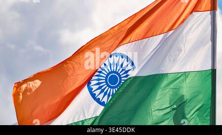 India flag with tricolor and Ashoka Chakra waving in wind on cloudy day Stock Photo
